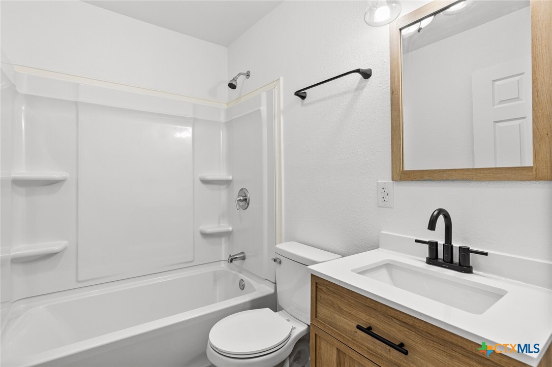 1020 South 23rd Street Temple, TX 76504 - Photo 23 of 38 a bathroom with a sink a toilet and shower