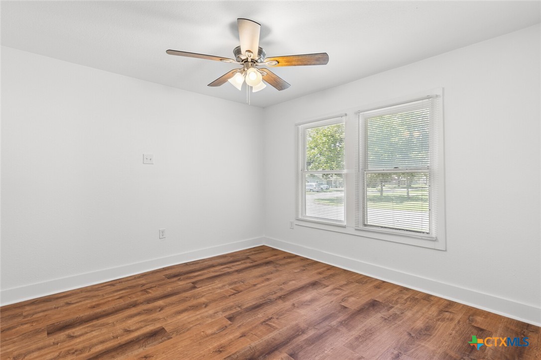 1020 South 23rd Street Temple, TX 76504 - Photo 24 of 38 an empty room with wooden floor fan and windows
