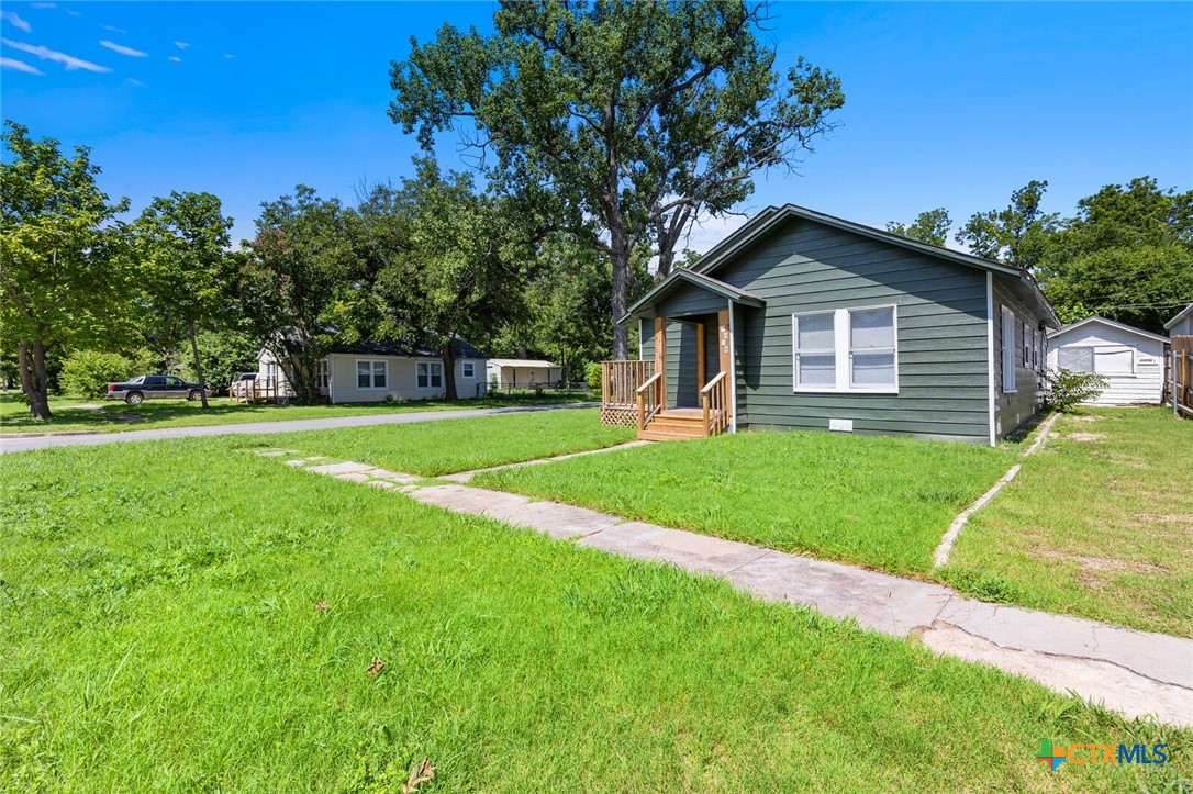 1020 South 23rd Street Temple, TX 76504 - Photo 3 of 38 a view of a house with a big yard and potted plants
