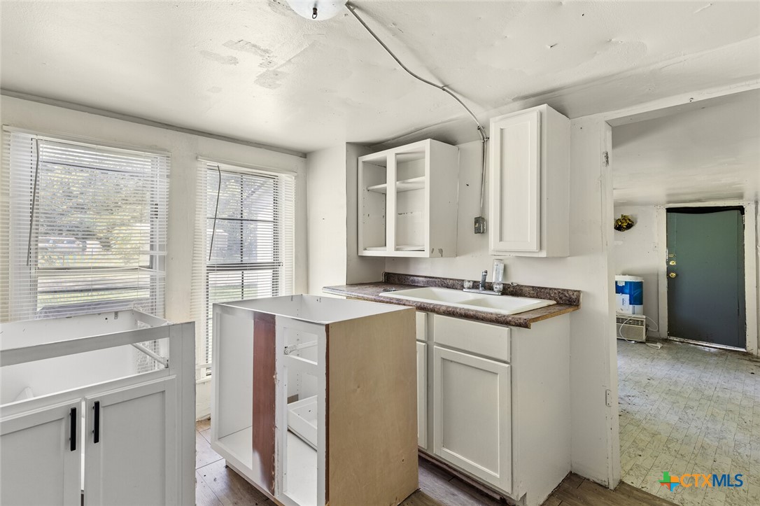 1020 South 23rd Street Temple, TX 76504 - Photo 35 of 38 a kitchen with a stove a sink and a refrigerator