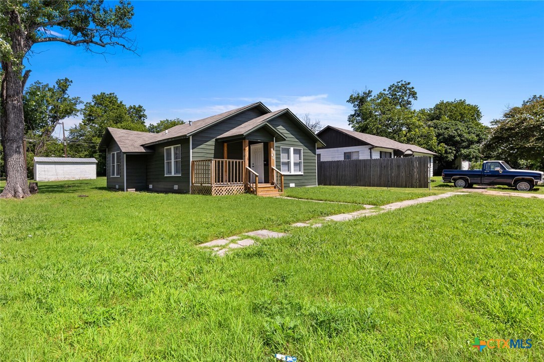 1020 South 23rd Street Temple, TX 76504 - Photo 5 of 38 a view of a house with a big yard and potted plants