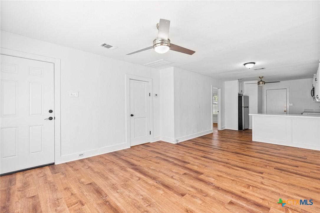 1020 South 23rd Street Temple, TX 76504 - Photo 9 of 38 a view of an empty room with wooden floor and a ceiling fan