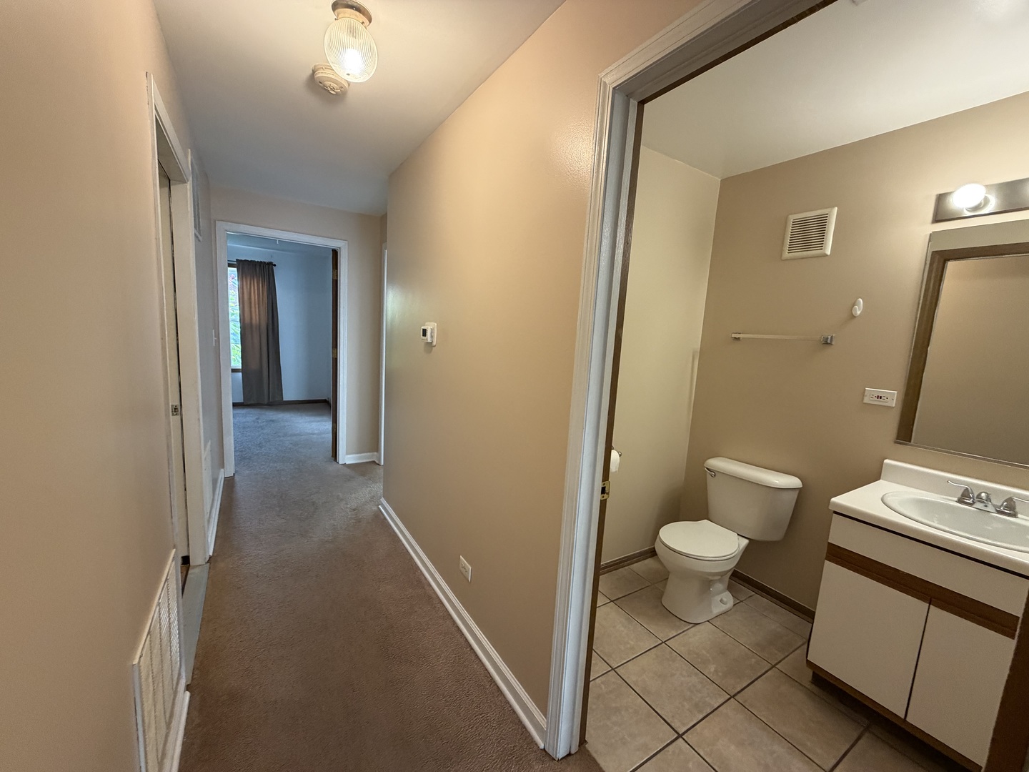 311 Sheffield Court, Unit 1 Roselle, IL 60172 - Photo 11 of 29 a bathroom with a sink and a toilet