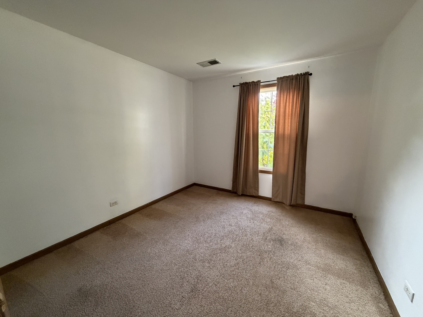 311 Sheffield Court, Unit 1 Roselle, IL 60172 - Photo 14 of 29 an empty room with windows