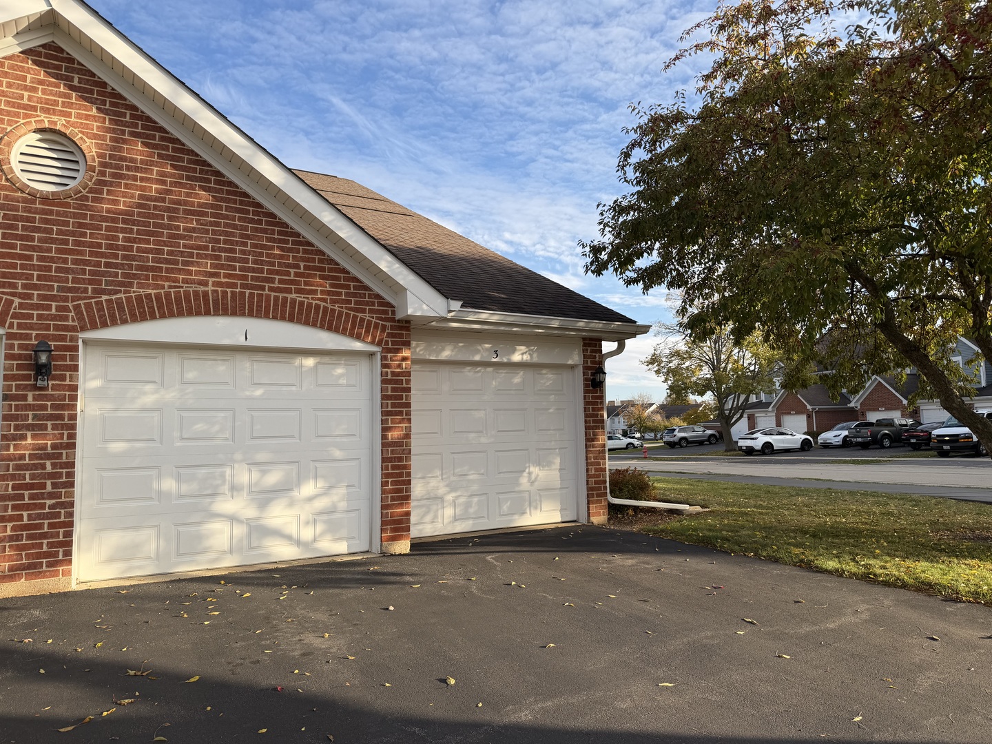 311 Sheffield Court, Unit 1 Roselle, IL 60172 - Photo 2 of 29 a front view of a house with a yard and garage