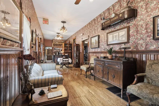 a hallway with a glass door shower and couch