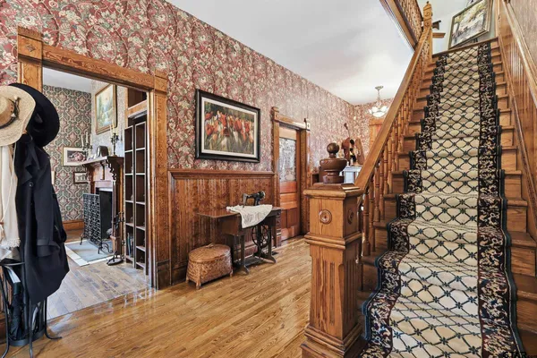 a bedroom with a large bed and a chandelier