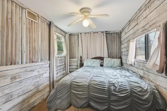 a view of a house with backyard and a tree