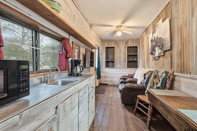 a view of a brick house with large trees