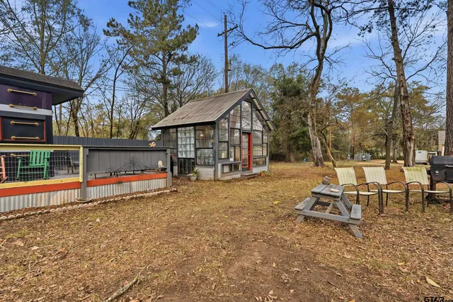 a view of a wooden deck with a yard