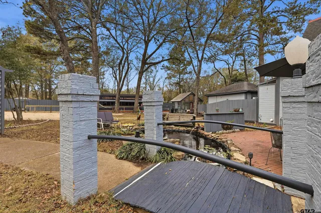 a view of backyard with outdoor seating and trees