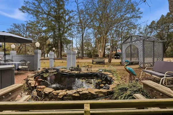 a view of a house with pool and chairs