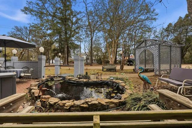 a view of a house with pool and chairs
