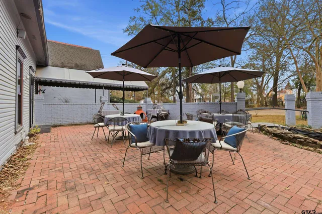 a view of a house with cars park