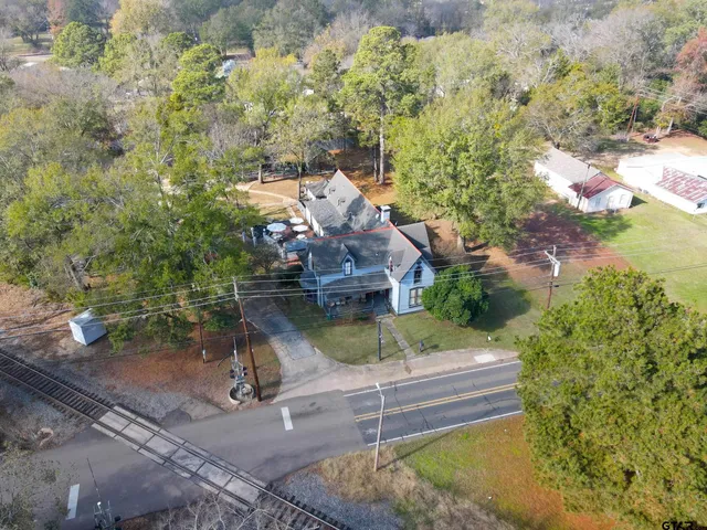 a view of a patio with table and chairs with wooden fence