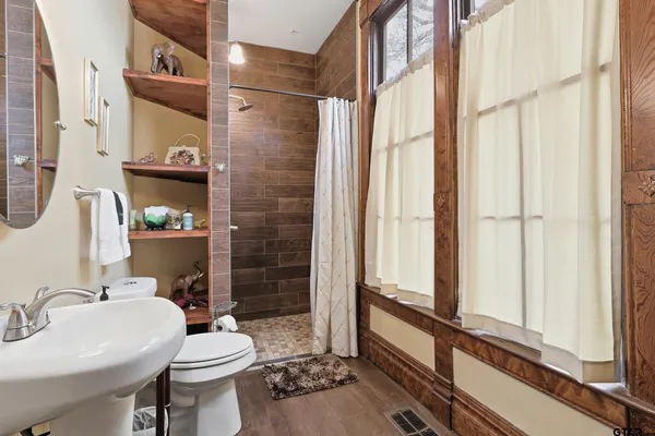 a living room with furniture a fireplace and a large mirror
