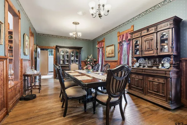 a kitchen with stainless steel appliances granite countertop a stove a sink dishwasher and cabinets with wooden floor