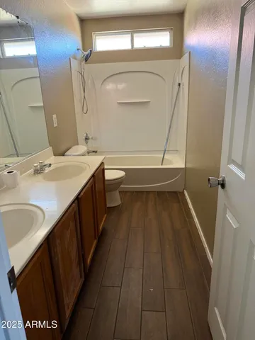 a bathroom with a sink a mirror and a toilet