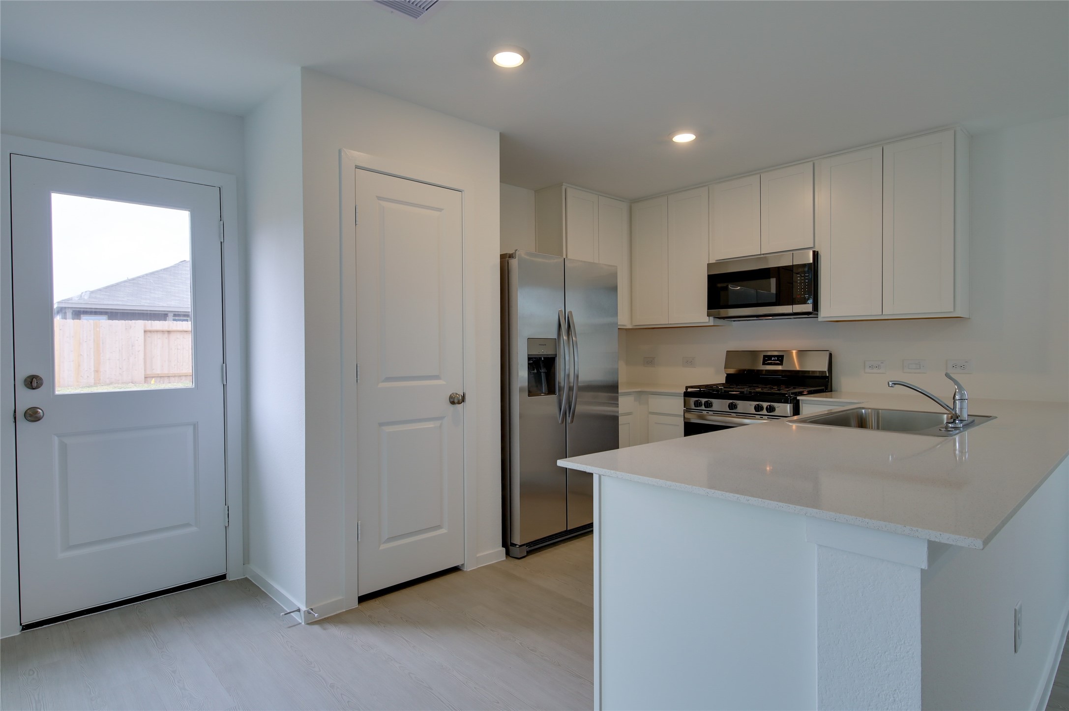 10915 Tawny Rdg Drive Beasley, TX 77417 - Photo 9 of 33 a kitchen with a refrigerator a stove top oven a sink and dishwasher
