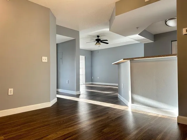 a view of an empty room with wooden floor