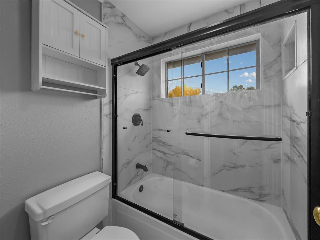 2317 Wellesly Road Rowlett, TX 75089 - Photo 20 of 39 a bathroom with a shower and a toilet