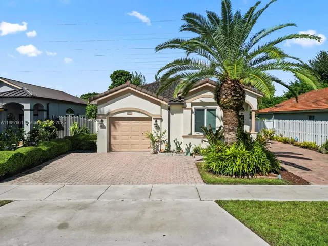 a view of a house with a yard and plants