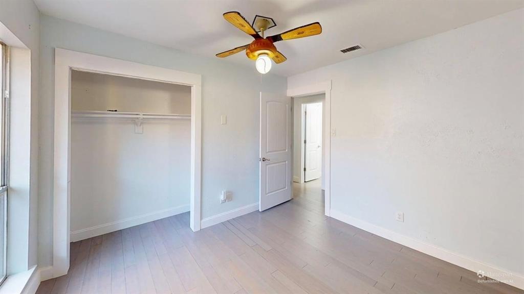 5805 Ranger Drive Rockwall, TX 75032 - Photo 11 of 24 an empty room with closet and a chandelier fan