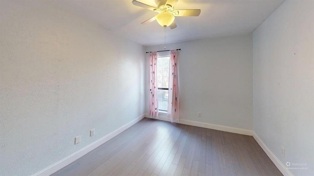 5805 Ranger Drive Rockwall, TX 75032 - Photo 12 of 24 wooden floor in an empty room with a window