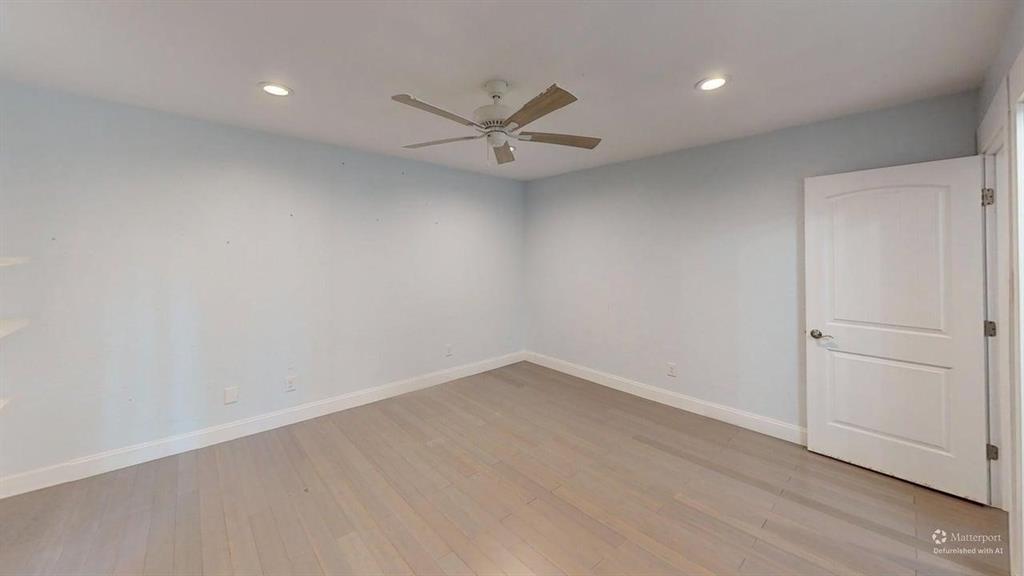 5805 Ranger Drive Rockwall, TX 75032 - Photo 14 of 24 an empty room with a ceiling fan and window