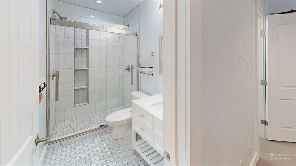 5805 Ranger Drive Rockwall, TX 75032 - Photo 16 of 24 a bathroom with a toilet and a shower
