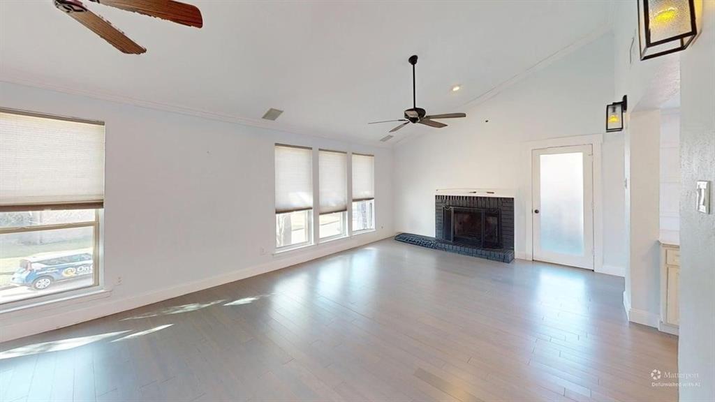 5805 Ranger Drive Rockwall, TX 75032 - Photo 6 of 24 a view of empty room with fireplace and wooden floor