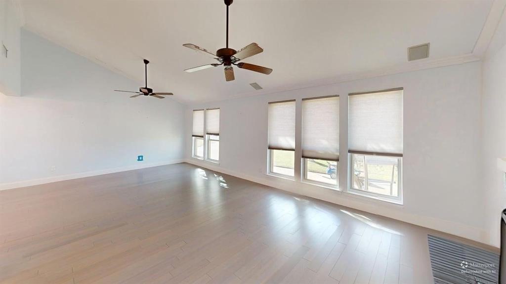 5805 Ranger Drive Rockwall, TX 75032 - Photo 7 of 24 a view of an empty room with a window and wooden floor