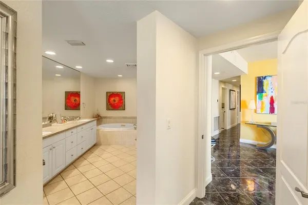 a view of a patio with couches and table and chairs under an umbrella