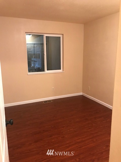 91 Hideaway Road Yakima, WA 98908 - Photo 20 of 25 a view of an empty room with wooden floor and a window