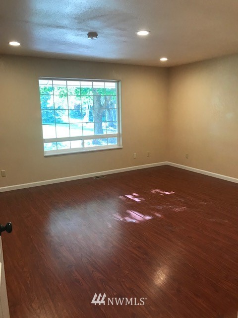 91 Hideaway Road Yakima, WA 98908 - Photo 21 of 25 an empty room with wooden floor and windows