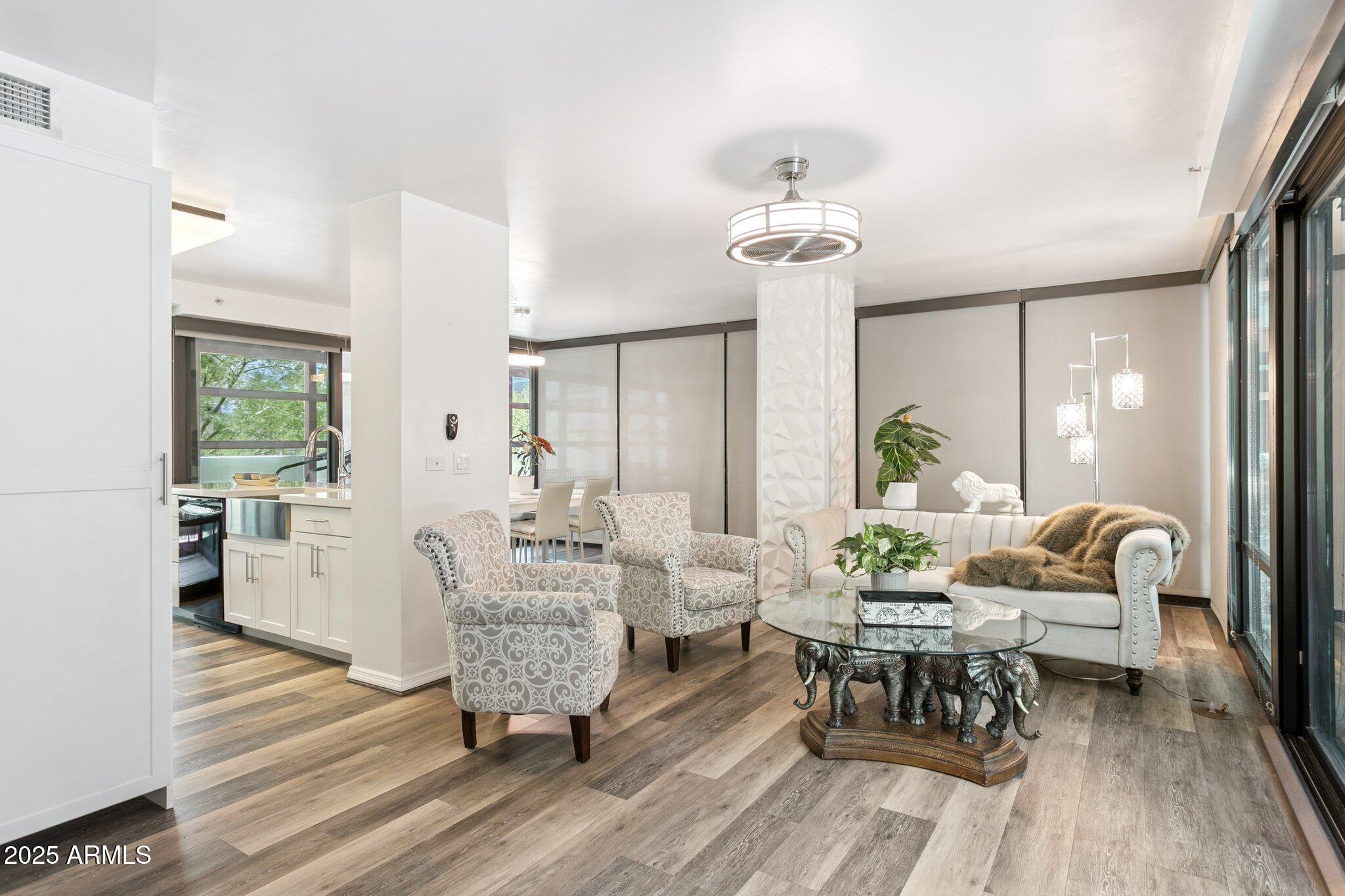 4808 North 24th Street, Unit 208 Phoenix, AZ 85016 - Photo 2 of 31 a living room with furniture and a chandelier