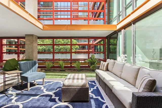 a living room with furniture a rug and a large window