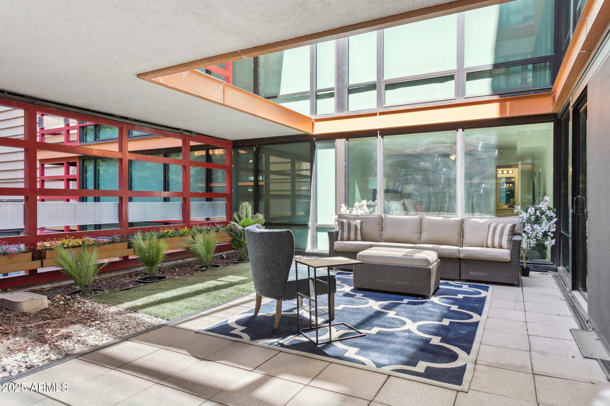 4808 North 24th Street, Unit 208 Phoenix, AZ 85016 - Photo 26 of 31 a living room with furniture a rug and a table