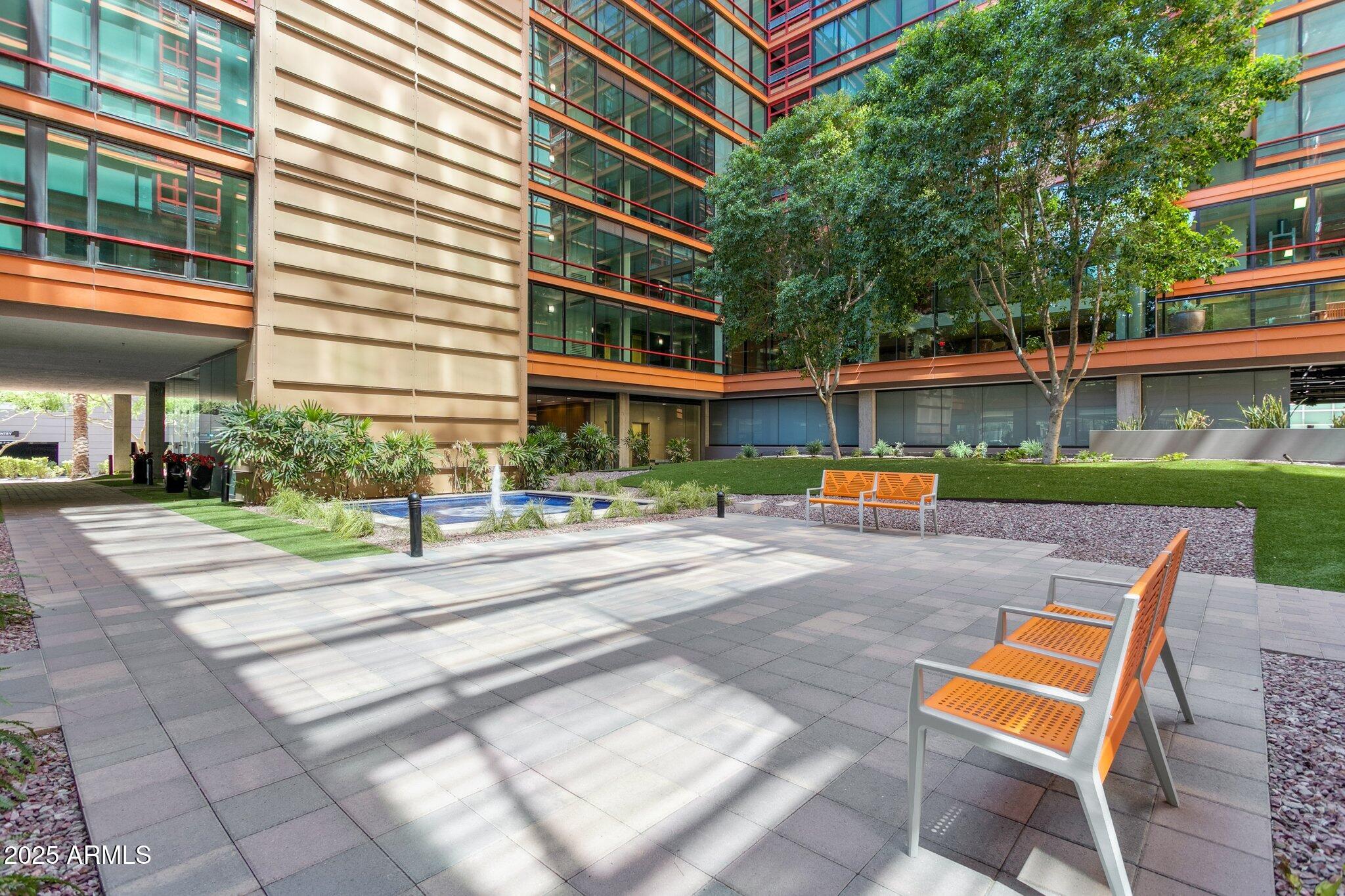4808 North 24th Street, Unit 208 Phoenix, AZ 85016 - Photo 29 of 31 a front view of a building with small garden and plants
