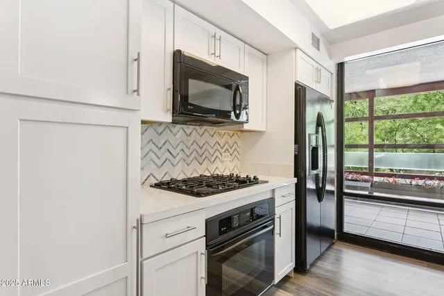 a kitchen with a stove and a microwave