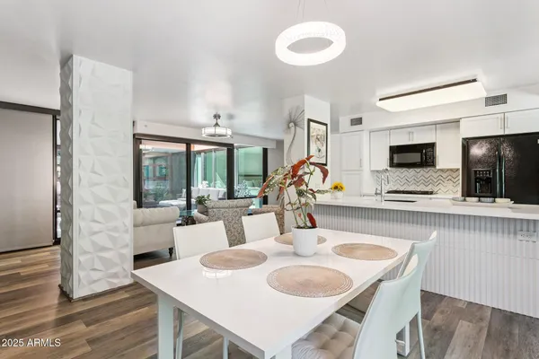 a dining room with furniture and a flat screen tv