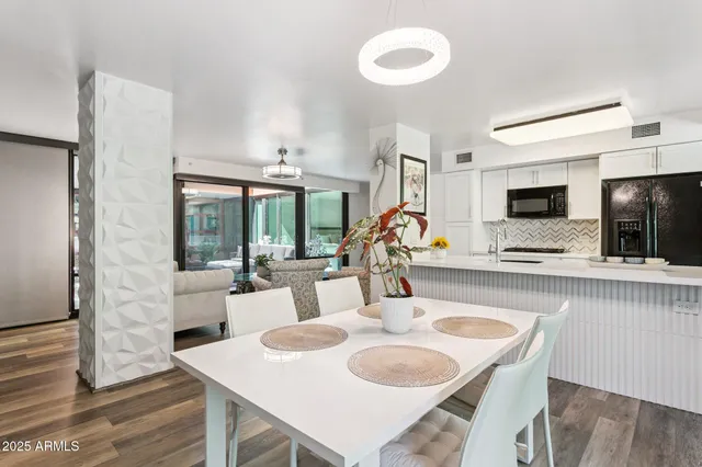 a dining room with furniture and a flat screen tv