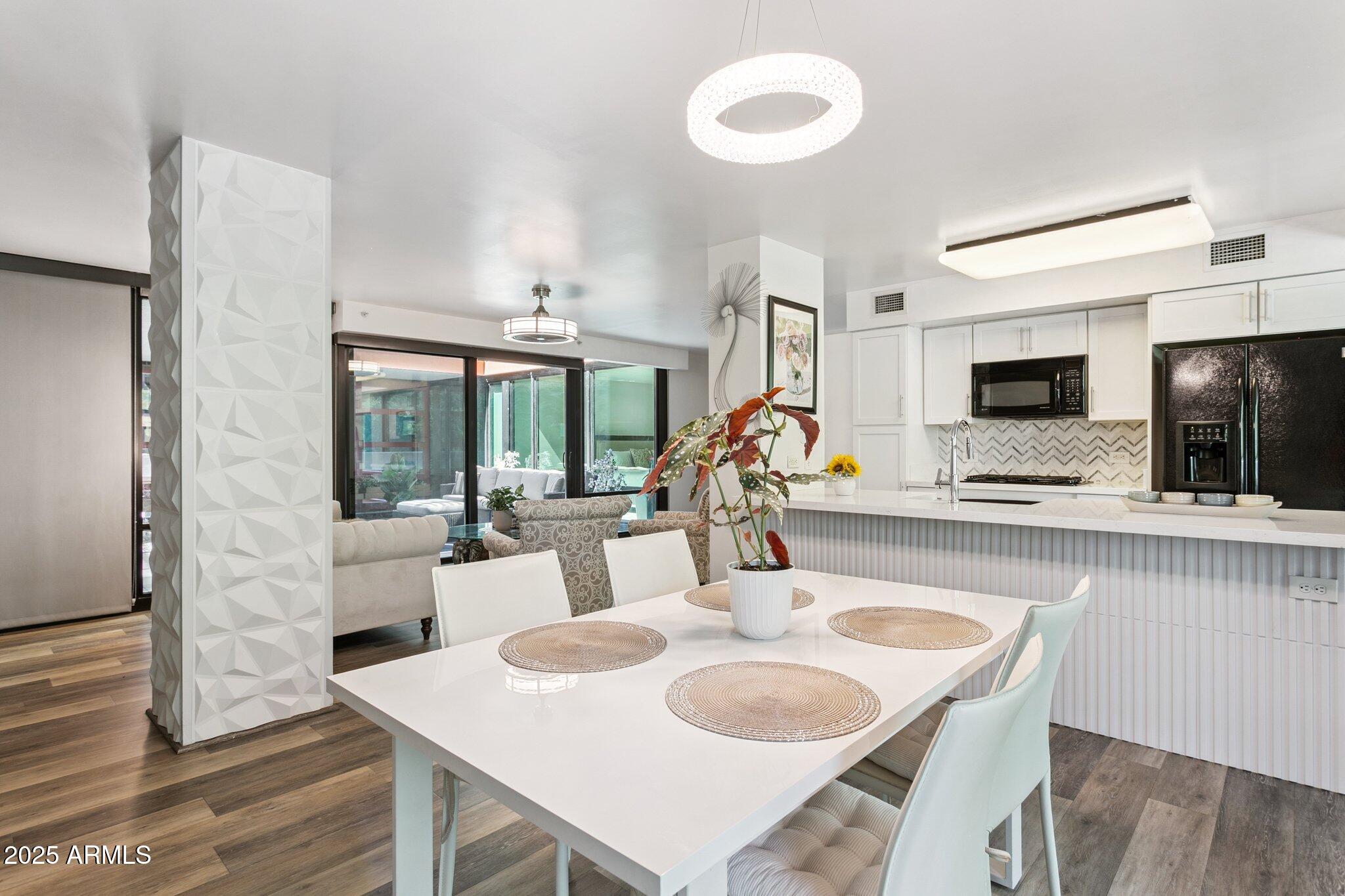 4808 North 24th Street, Unit 208 Phoenix, AZ 85016 - Photo 10 of 31 a dining room with furniture and a flat screen tv