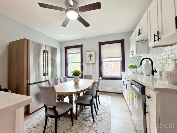 a kitchen with stainless steel appliances white cabinets a sink a stove a microwave and wooden floors