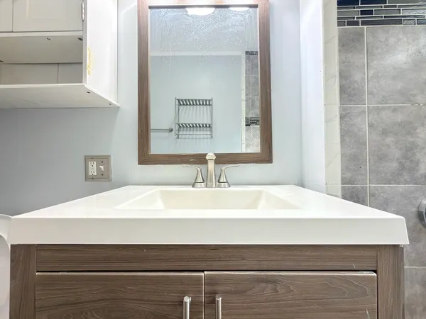 a bathroom with a sink mirror vanity and toilet