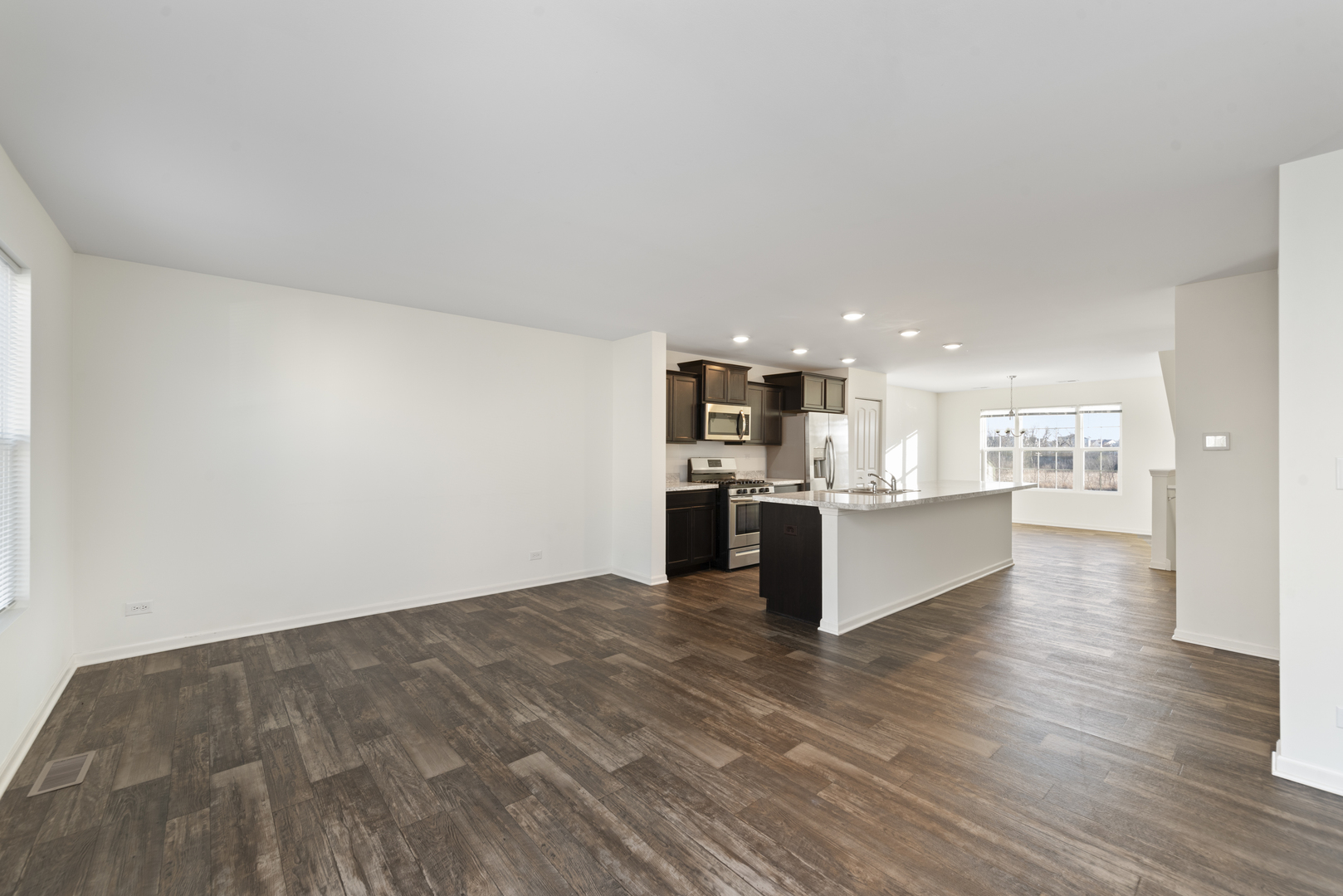 2327 Upland Road Pingree Grove, IL 60140 - Photo 4 of 16 a view of kitchen with kitchen island refrigerator stove microwave and cabinets