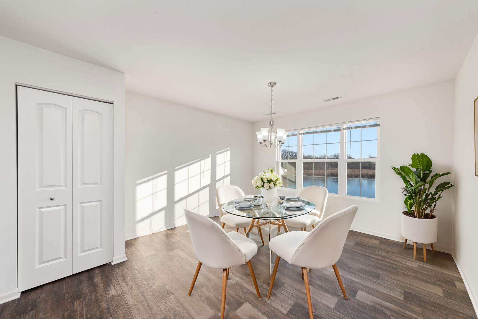 2327 Upland Road Pingree Grove, IL 60140 - Photo 6 of 16 a dining room with furniture potted plants and wooden floor