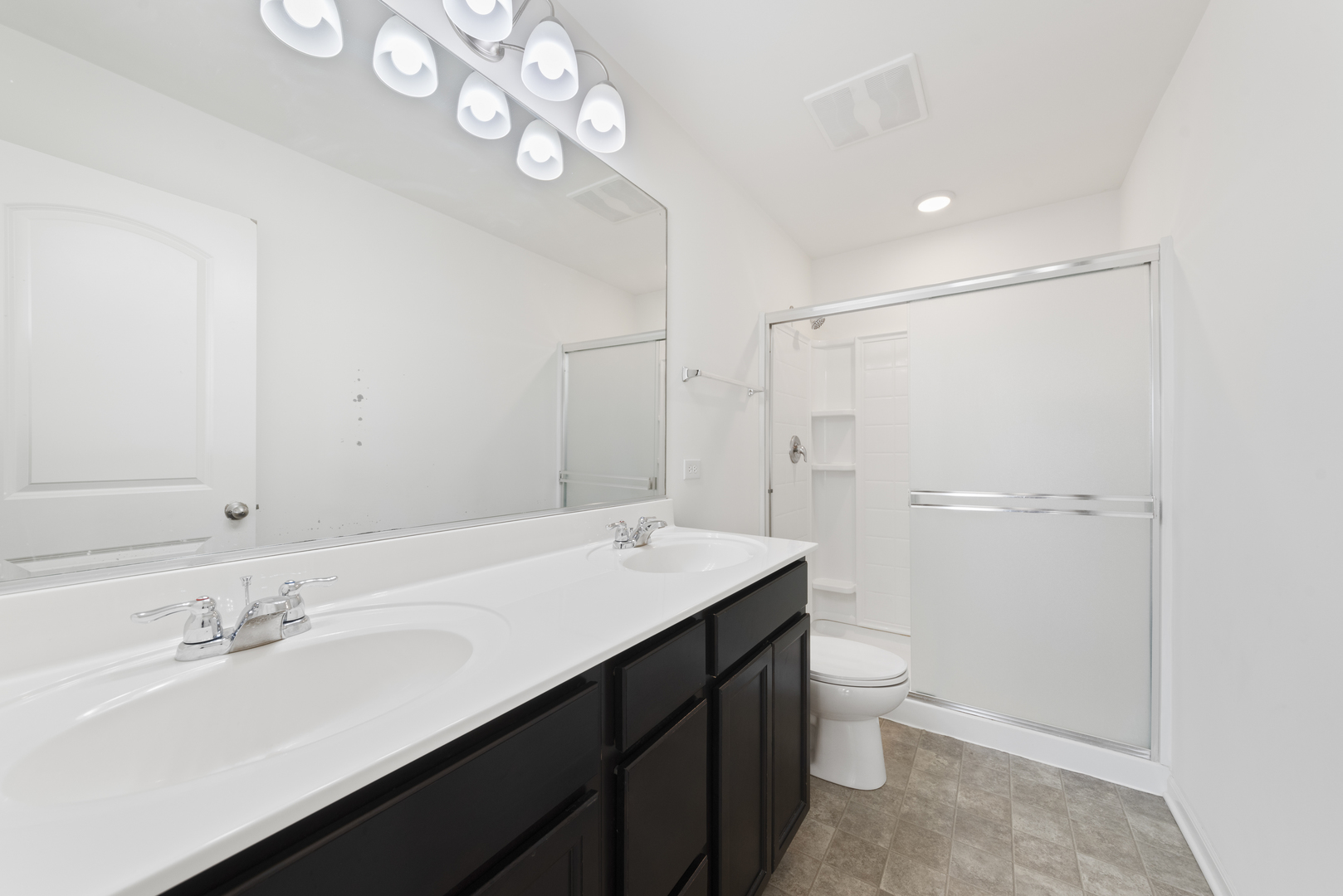 2327 Upland Road Pingree Grove, IL 60140 - Photo 9 of 16 a bathroom with a sink a toilet a mirror and shower