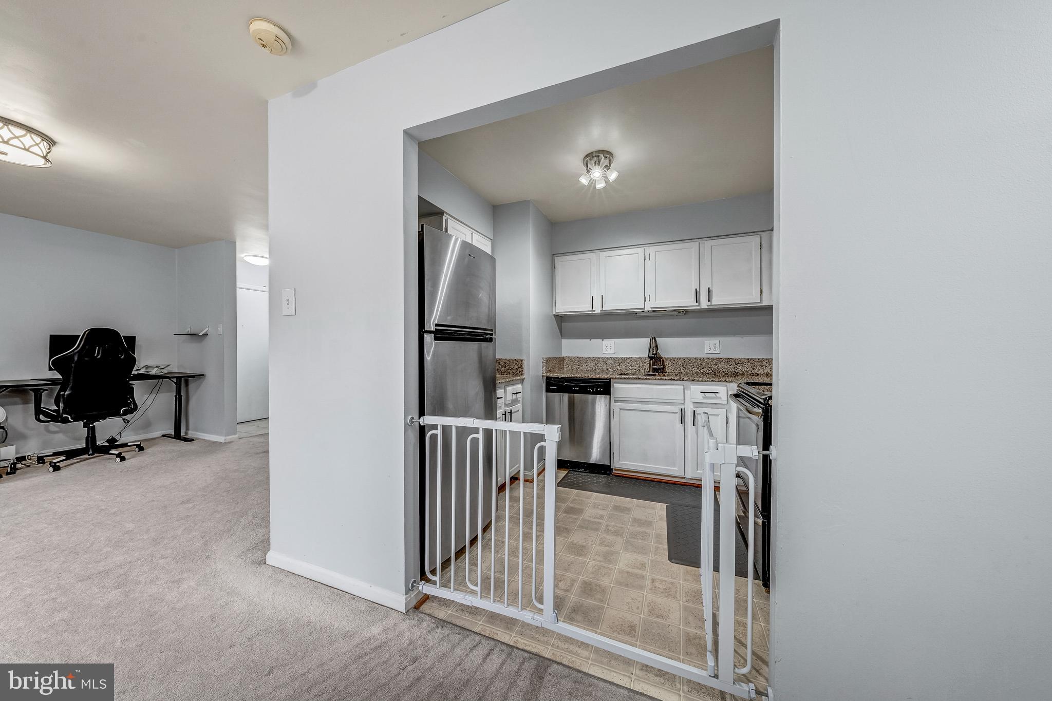 6137 Edsall Road, Unit I Alexandria, VA 22304 - Photo 12 of 28 a kitchen with kitchen island a counter top space a sink and appliances