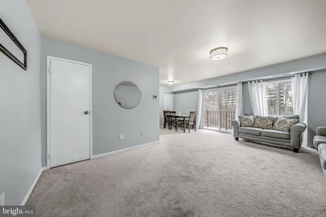 a living room with furniture a window and gym equipment